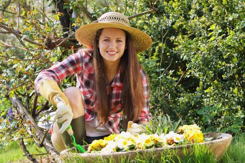 Gardeners operating equipment with safety measures in place
